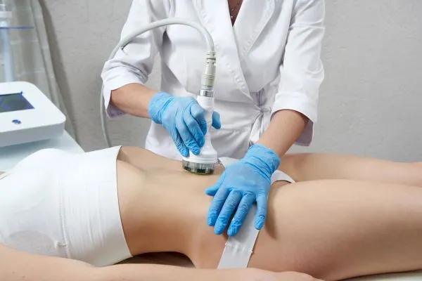 Lost the Weight but Not the Loose Skin? 2 woman having HIFU treatment on her stomach to combat loose skin Suffolk following weight loss